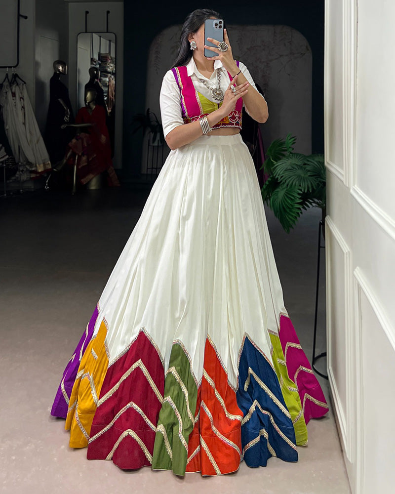 AWESOME WHITE RAYON NAVRATRI LEHENGA CHOLI WITH MULTICOLOR BORDER